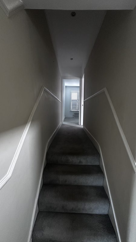 The narrow stair to the top floor.