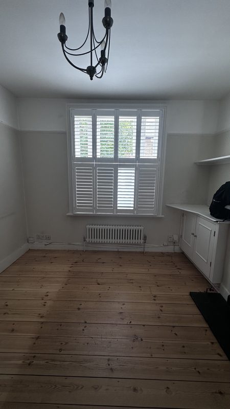 A first floor room with shutters, before the work.