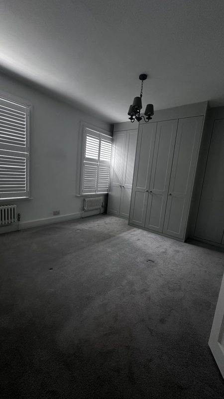 A bedroom with fitted wardrobes, before the work.