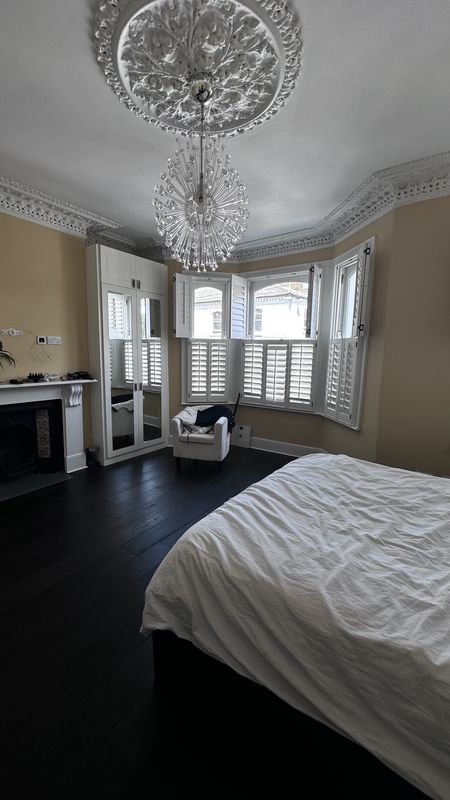 The principal bedroom before the work, a bay window and an ornate ceiling rose