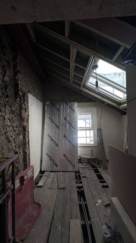 The loft opened up, the roof window and insulation going in