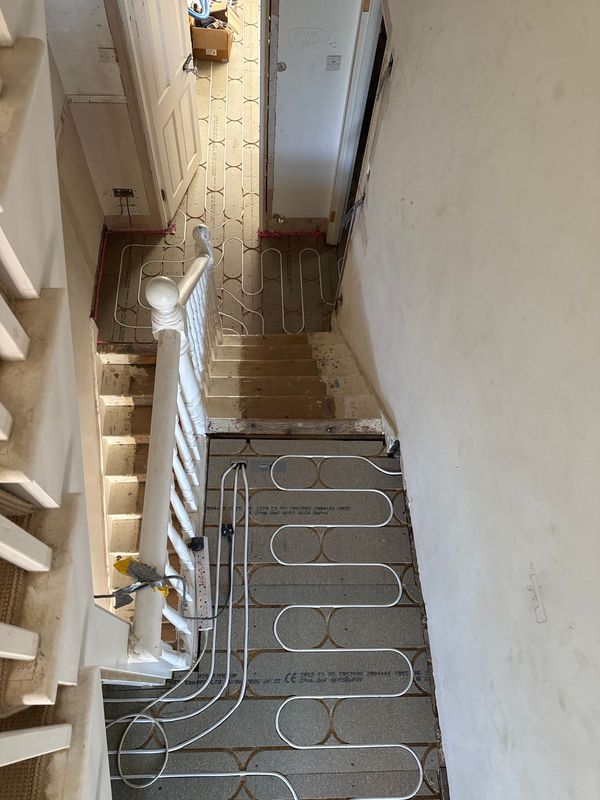 Underfloor heating pipe laid up to the stair