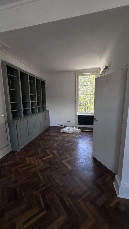 The drawing room before the work, herringbone floor and built-in shelving