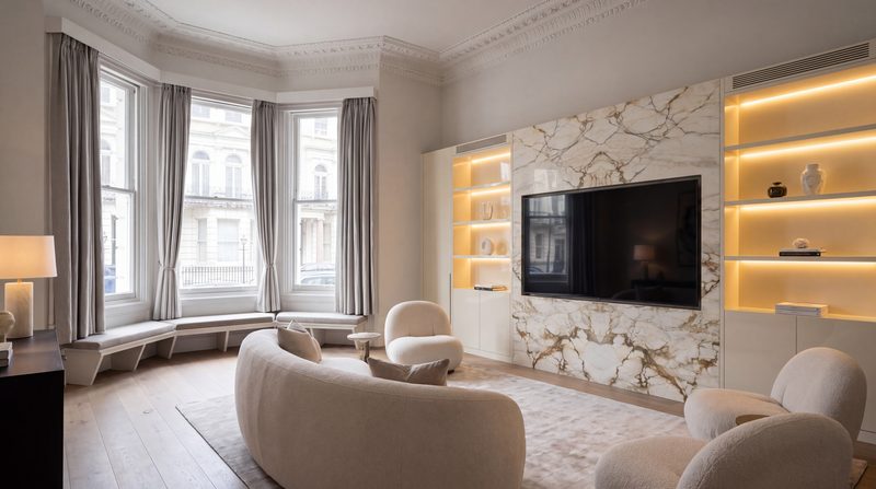 Drawing room shown as designed, a book matched marble media wall in the bay windowed room. A visualisation.
