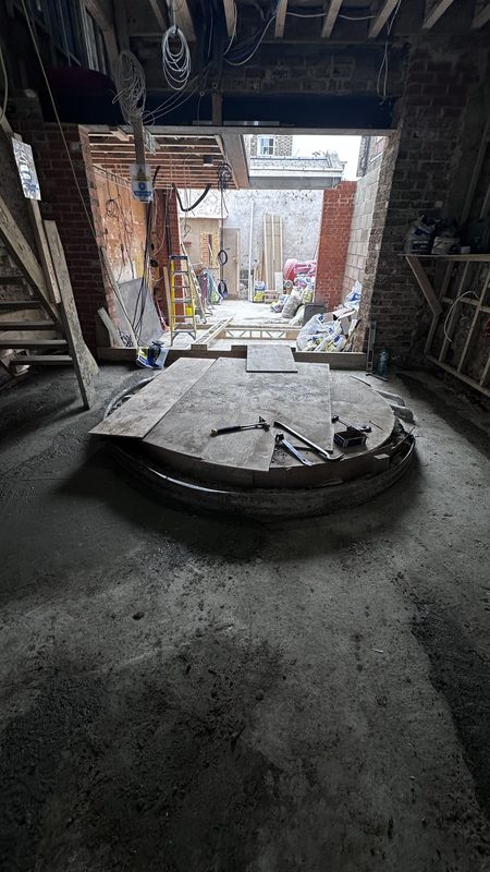 The circular opening formed for the spiral wine cellar, in the new ground floor.