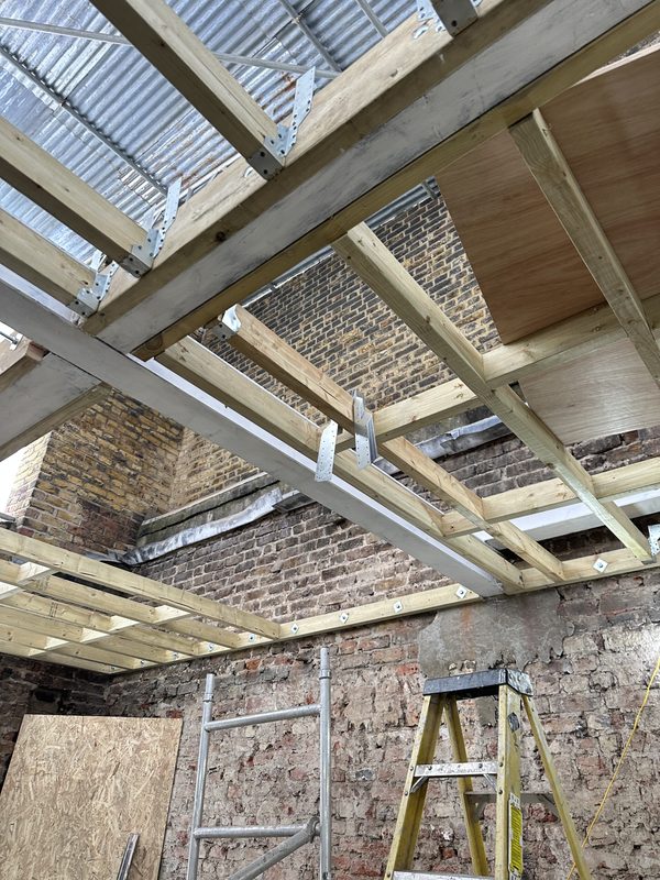 New timber and steel floor structure against the old brick walls.