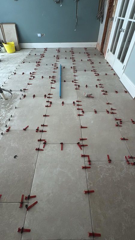 Large format floor tiles being laid