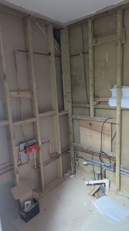 A bathroom stud wall, plumbing in