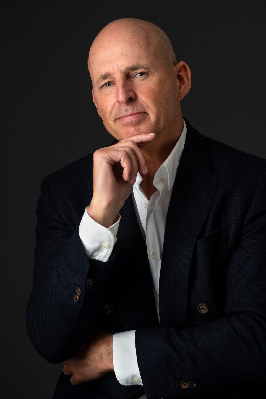 Nick Jeffries, founder of NU Projects, in a navy blazer and open white shirt