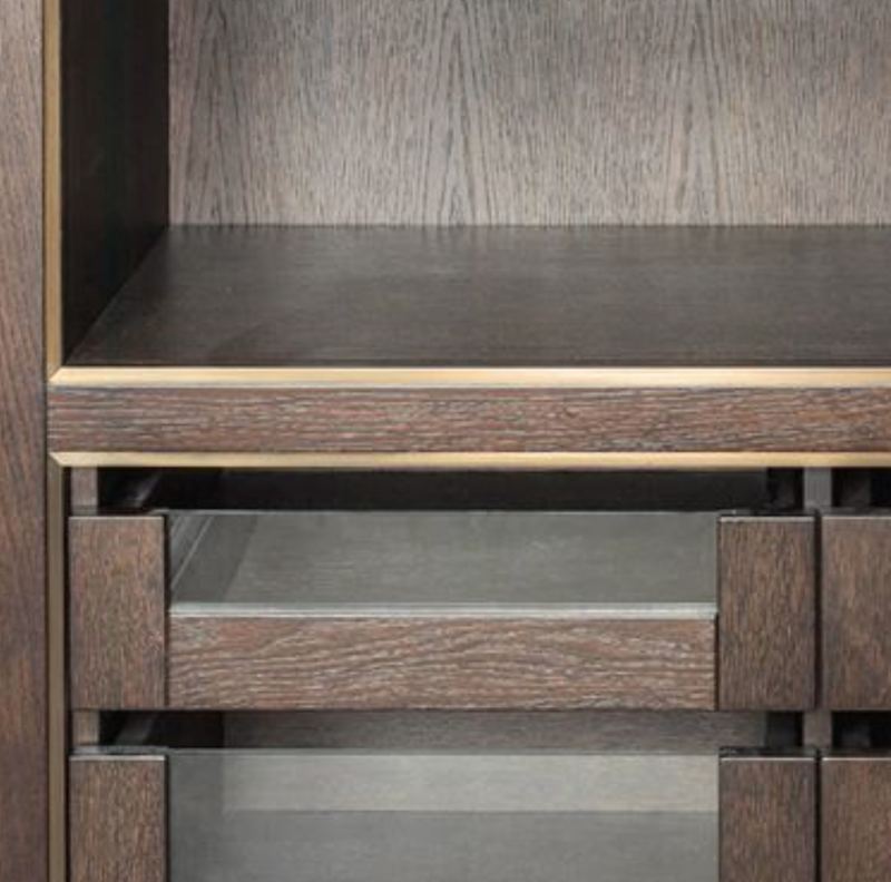 Fumed oak open shelving with bronze edges over glass fronted drawers.