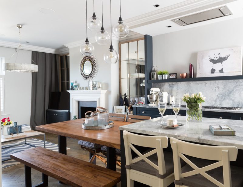 Finished London kitchen and dining room. A recessed stainless extract and ceiling grilles sit in a dropped ceiling raft above a marble island.