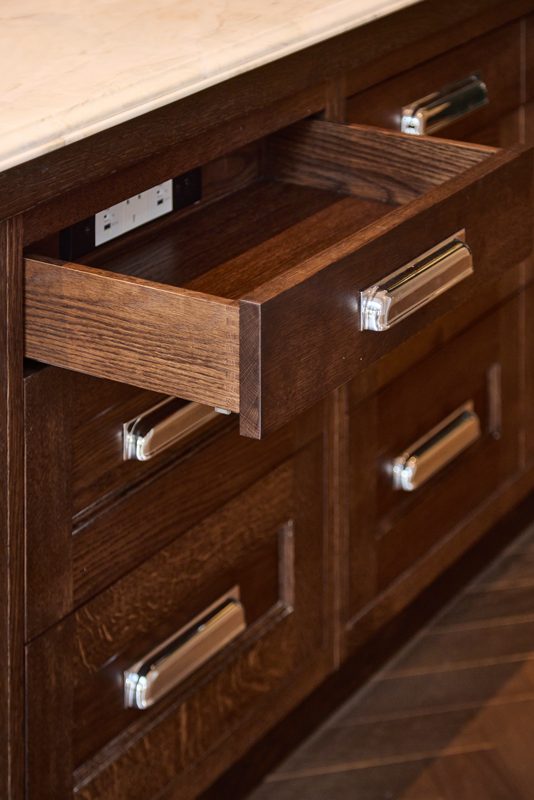Walnut drawer pulled open to show dovetailed corners.