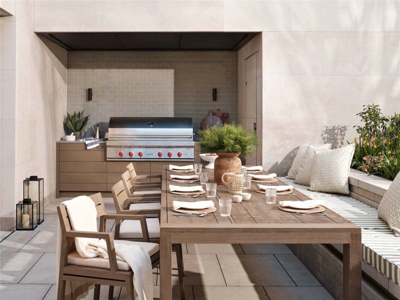 Roof terrace with an outdoor kitchen and planted borders.