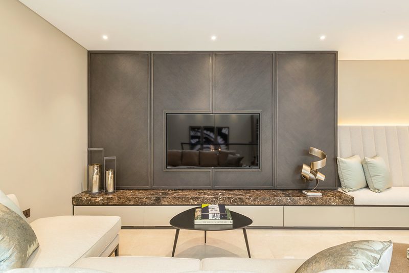 Living room with a television set into panelled joinery.