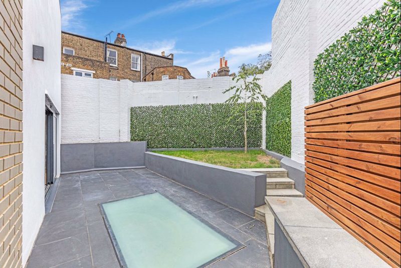 Rear courtyard with a glass rooflight set into the paving.