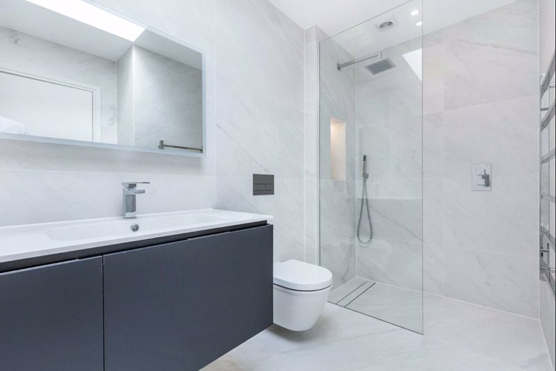 Bathroom with large format tiles and a walk in shower.