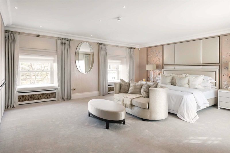 Bedroom with an upholstered headboard and bedside lamps.