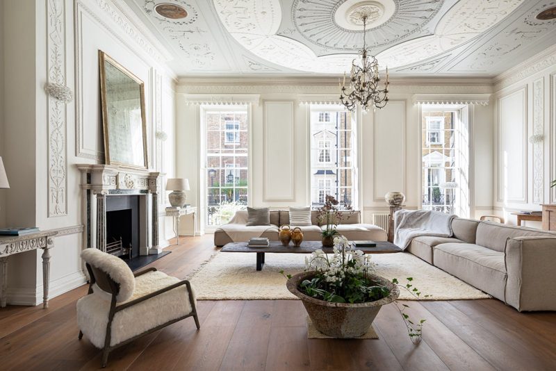 Drawing room with ornate Georgian plasterwork, a marble chimneypiece and tall sash windows.