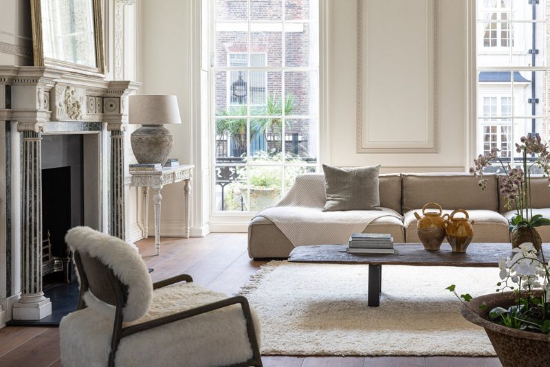 Marble chimneypiece beside a tall sash window in the drawing room.