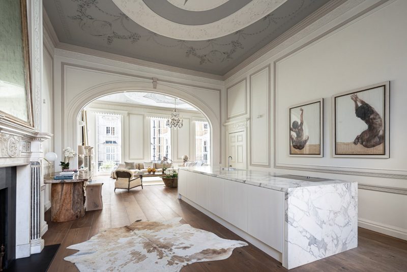 Kitchen island and chimneypiece, looking through the arch to the drawing room.