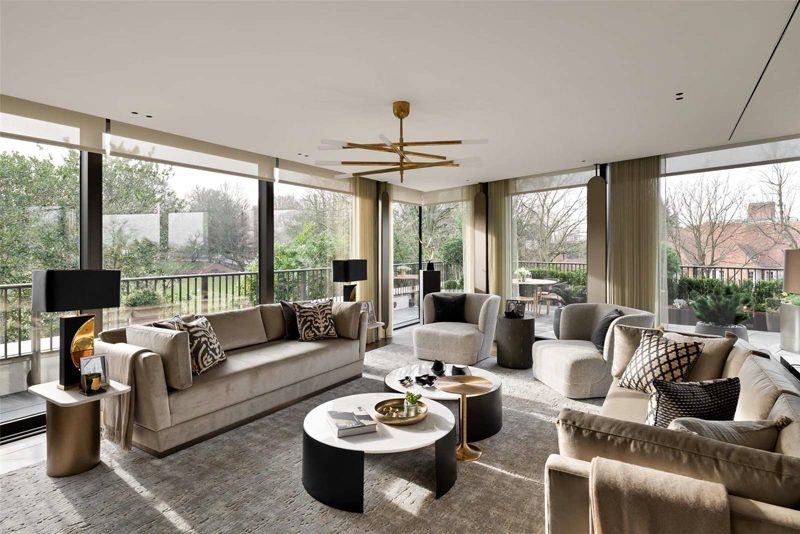 Living room with full height glazing onto a planted terrace.