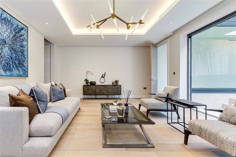 Living room with a glazed wall onto a planted light well.
