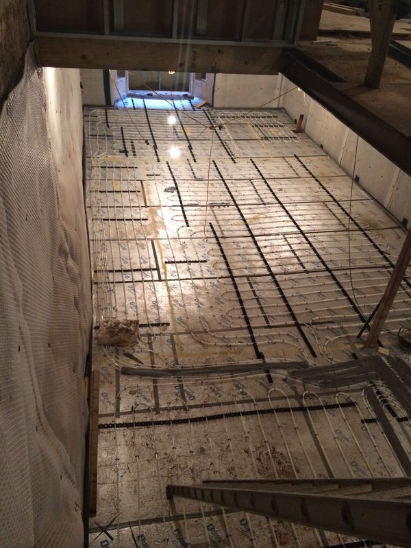 Underfloor heating pipes laid in loops across a lower ground floor, before the floor goes down.